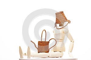 Image of wooden figure rusty miniature bucket watering can white background