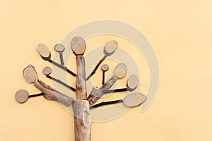 Image of wooden growing family tree on pastel background