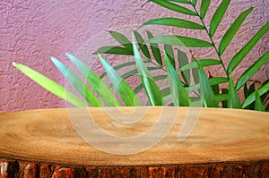 image of wooden table in front tropical green floral background. for product display and presentation