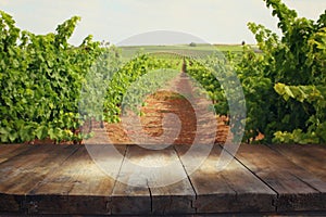 Image of wooden table in front of Vineyard landscape