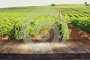 Image of wooden table in front of Vineyard landscape