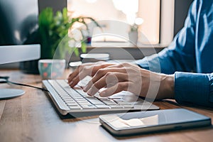 Image Workplace productivity close up of mans hands typing on keyboard