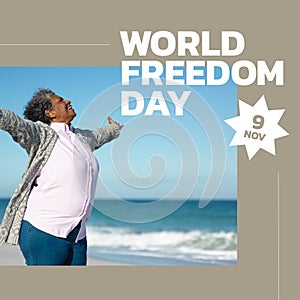 Image of world freedom day over happy afican american senior woman man on beach