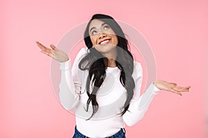 Image of young asian woman smiling and looking upward at copyspace