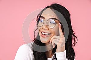 Image of young asian woman wearing eyeglasses smiling and looking aside