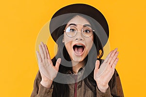 Image of young brunette asian woman expressing surprise with emotions