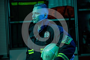 Image of young fireman looking to side , neon effect