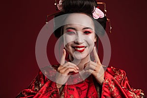 Image of young geisha woman in traditional japanese kimono smiling