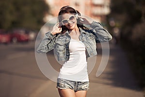 Image of young happy woman, listening music and having fun