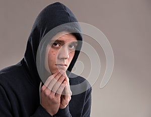 Image of young man in hooded sweater