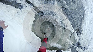 Image of young man mountaineer standing atop of rock at dangerous Couloir passage toward Mont Blanc