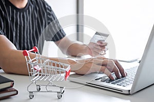 Image of Young man using smartphone for online shopping website and pay by credit card, Online payment and shopping concept