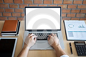 Image of Young man working in front of the laptop looking at screen with a clean white screen and blank space for text and hand