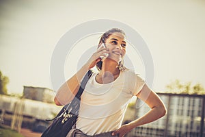 Image of young sport woman talking phone.