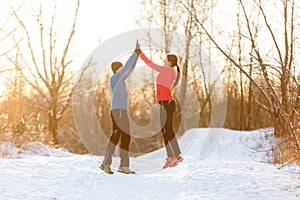 Image of young sportsmen doing handshake in winter park at afternoon