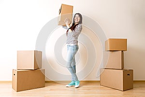 Image of young woman among cardboard boxes