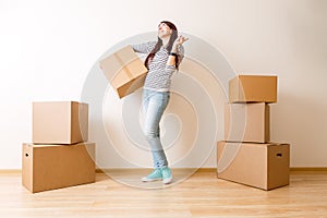 Image of young woman among cardboard boxes