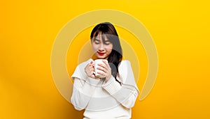 Image of young woman having fun enjoying coffee cup at home smiling beautiful girl drinking hot tea in winter and smiling happily