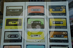 Images of cassette tapes on a poster in the shop window.