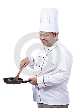 Images of chef cooking view side with holding pan and spatula