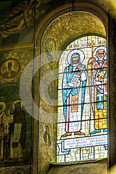 Images of Orthodox saints on the stained glass window of the church