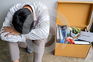 Images of packing up all his personal belongings and files into a brown cardboard box, Businessman has frustrated and stressed to