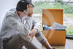 Images of packing up all his personal belongings and files into a brown cardboard box, Businessman has frustrated and stressed to