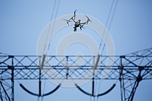 Images of power line tower. Drone making inspection around it.