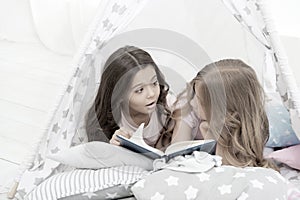 Imagination ran away with them. Little girls read and imagine during bedtime. Cute dreamers with book. Kids imagination photo
