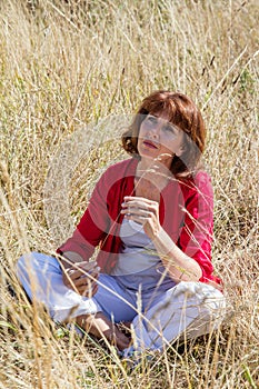 Imaginative young senior woman in harmony with nature