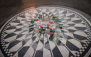 The Imagine mosaic with flowers on day of John Lennon death at Strawberry Fields in Central Park, Manhattan - New York, USA