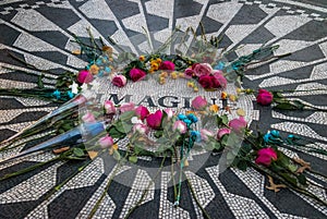 The Imagine mosaic with flowers on day of John Lennon death at Strawberry Fields in Central Park, Manhattan - New York, USA