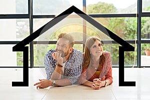 Imagine owning our dream house.... Shot of a young couple dreaming about a new house.