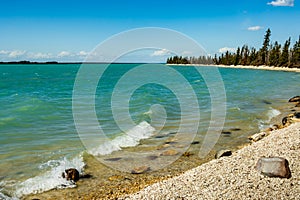 Turquoise water of Little Limestone Lake in Northern Manitoba on a sunny day photo