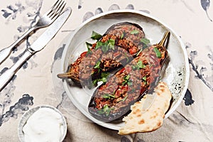 Imam bayildi. Traditional delicious Turkish food: halves of baked eggplant stuffed with vegetables