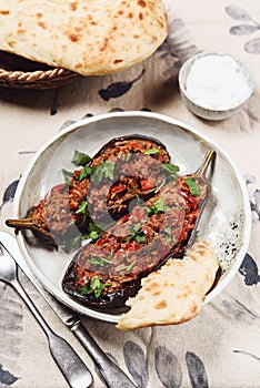 Imam bayildi. Traditional delicious Turkish food: halves of baked eggplant stuffed with vegetables