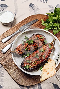 Imam bayildi. Traditional delicious Turkish food: halves of baked eggplant stuffed with vegetables