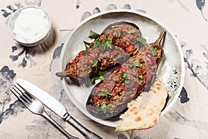 Imam bayildi. Traditional delicious Turkish food: halves of baked eggplant stuffed with vegetables