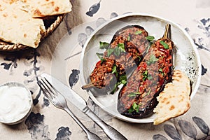 Imam bayildi. Traditional delicious Turkish food: halves of baked eggplant stuffed with vegetables