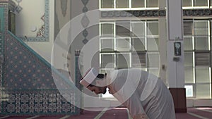 Imam praying takbir in mosque side wide