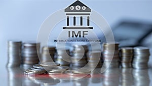 IMF. International Monetary Fund. Finance and banking concept. Coins background