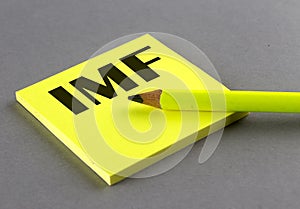 IMF International Monetary Fund text written on a sticky on grey background