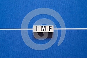 Imf word concept on cubes photo