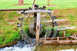 Imitattion of water mill. Village watermill. Turning water-mill. Working watter mill on the brook