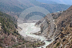 Mountain valley with flowing river in Himalayas photo