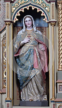 Immaculate heart of Mary statue on the Sacred heart of Jesus altar in the church of Saint Matthew in Stitar, Croatia