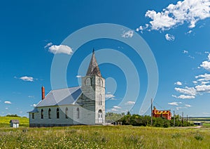 Immanuel Lutheran Church with grain elevator in Admiral, Saskatchewan, Canada