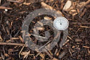 Immature compost managed in a community composter with one thermometer to control the process. Concept of recycling and