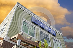 Immediate Care Sign On Hospital Building with Clouds