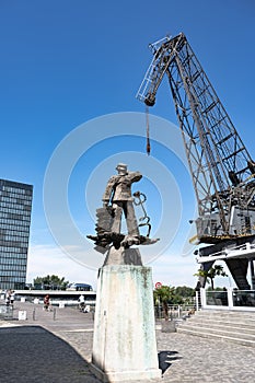 Immendorff staue `Hans Albers` a singer and actor as sailor and old cranes in Medienhafen, Media Harbor, Media Harbour, Dusseldorf